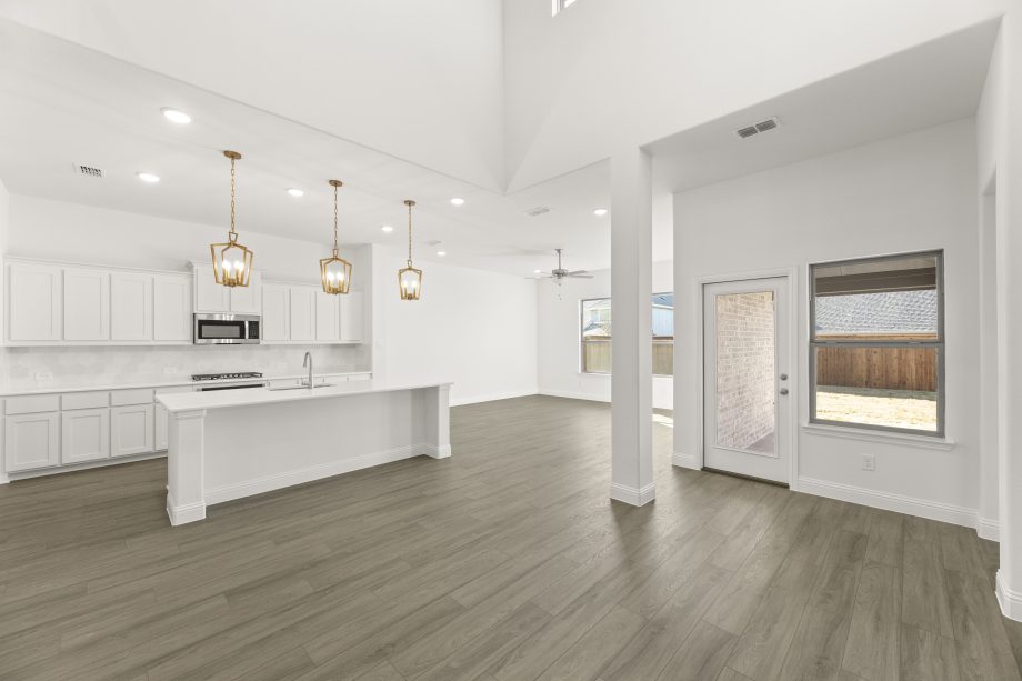 Open-concept kitchen and living area in a 4 bedroom, 3 bath new construction home starting at 2,534 square feet, available in Van Alstyne and Royse City, TX.
