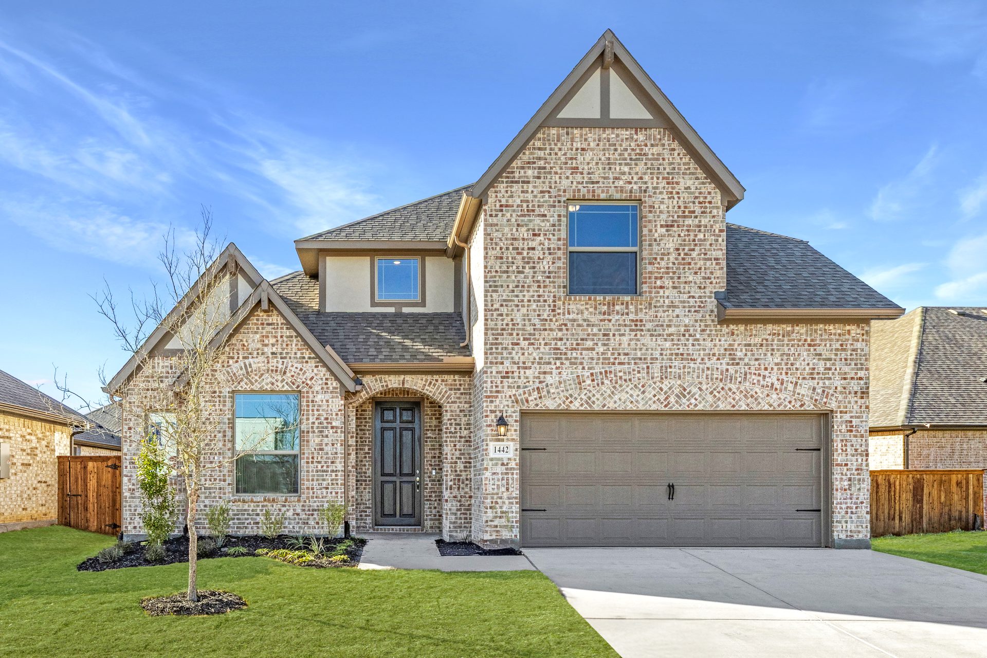 Bright open-concept kitchen and living area in a 4-bedroom, 3-bath new construction home starting at 2,534 square feet, featuring a large island, modern finishes, and open sightlines, available in Van Alstyne and Royse City, Texas.