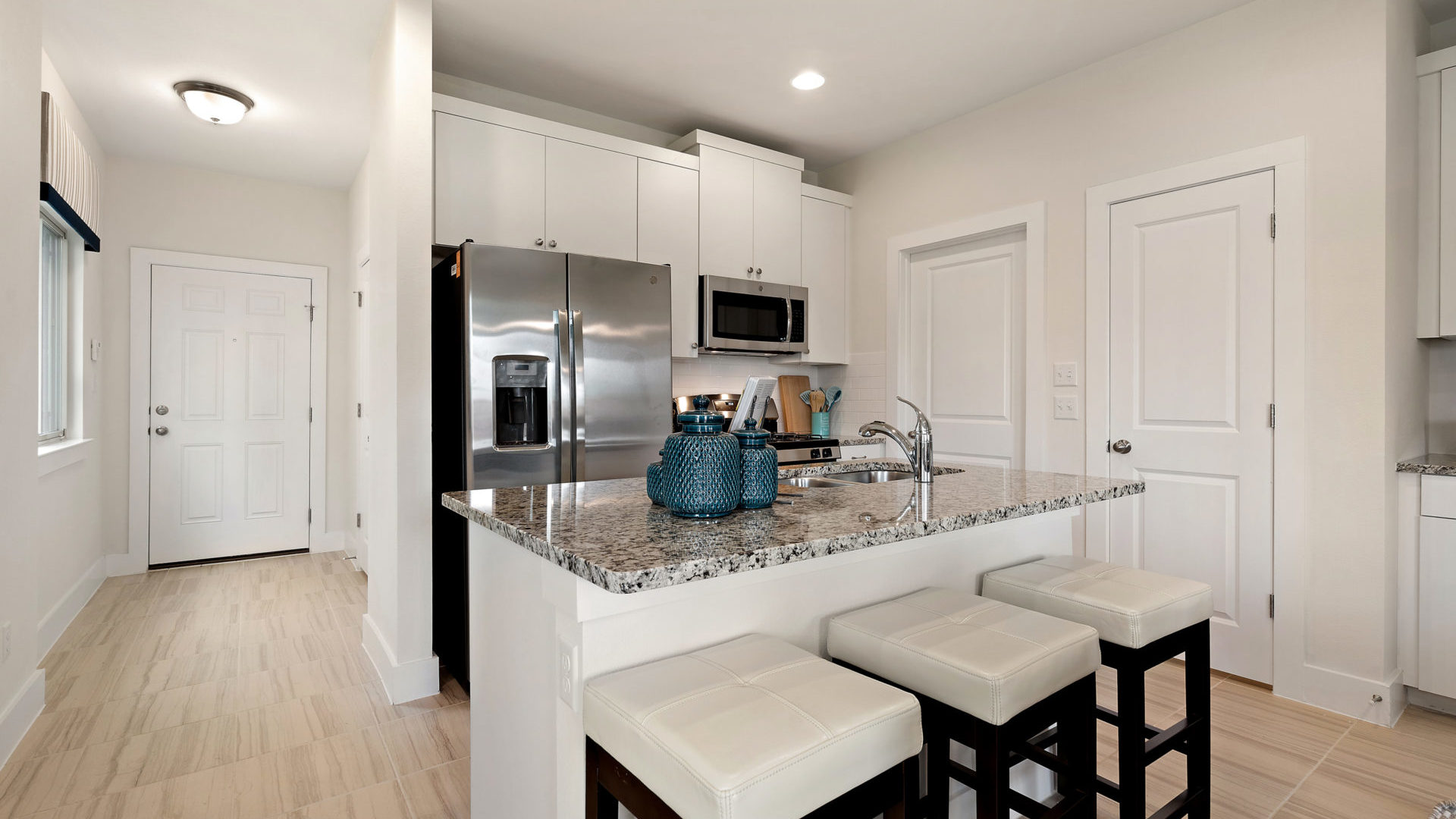 shasta twinhome white kitchen with island and granite counters